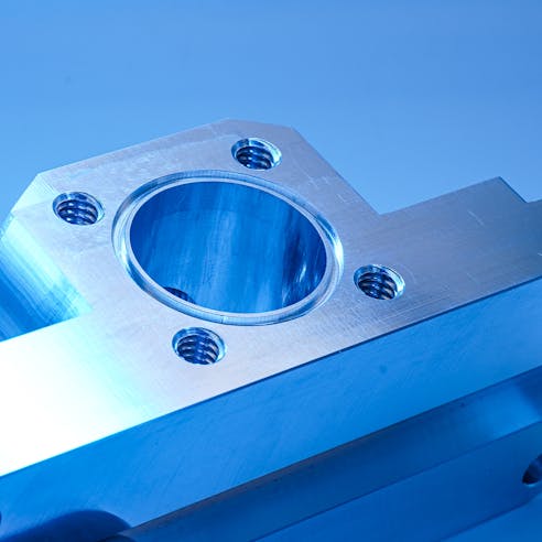A threaded aluminum part made by Xometry.