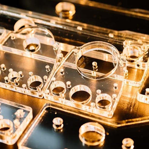 Laser cut acrylic machine parts. Image Credit: Shutterstock.com/ValeriiaES
